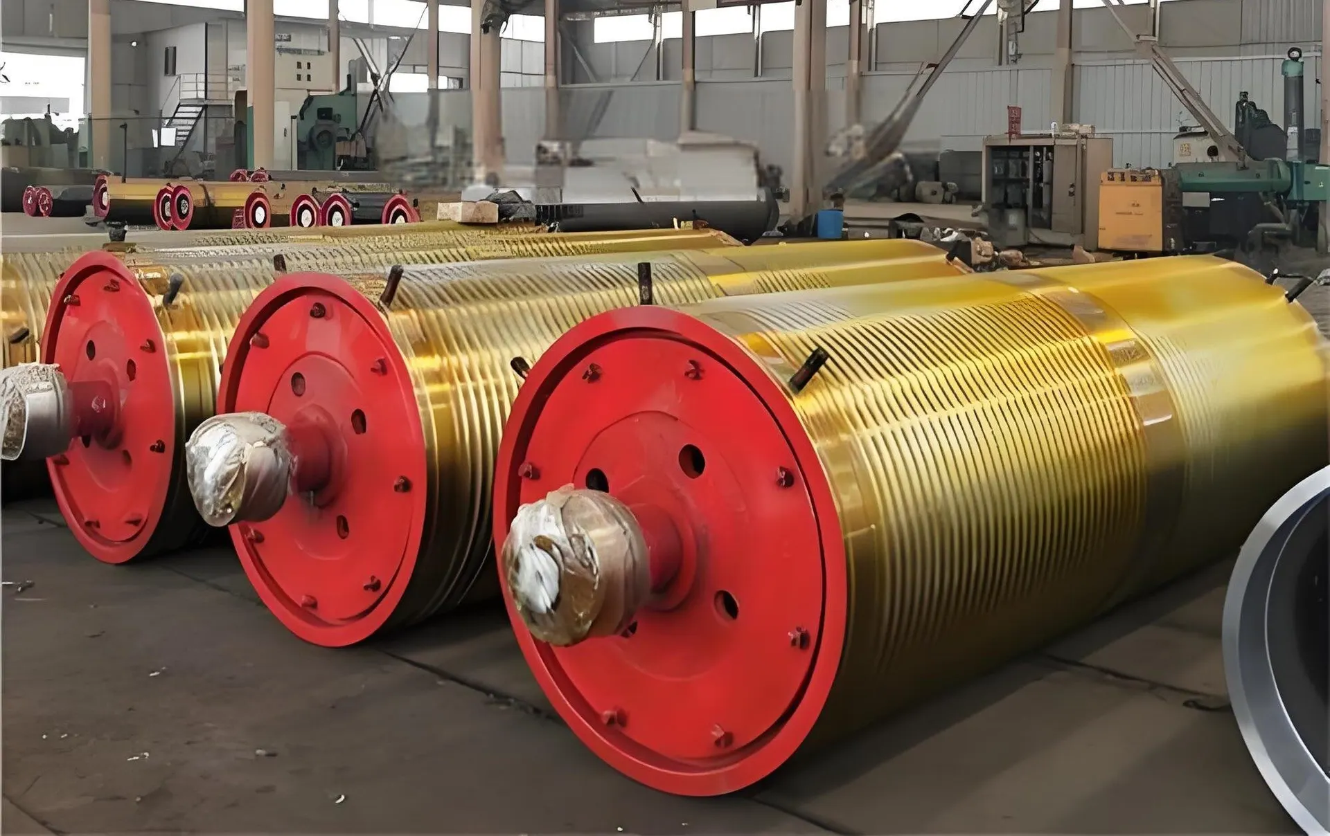 Machined rope drums with grooved barrels waiting on the shop floor