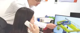 Sales engineer discussing a crane specification with a customer on screen
